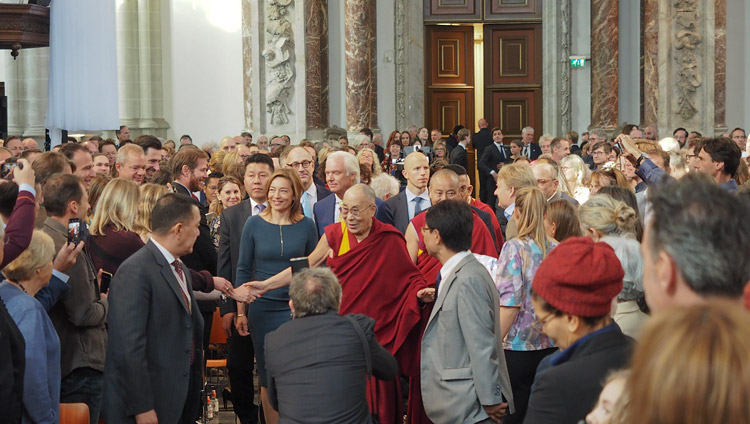 Escorted by the Nieuwe Kerk Director Cathelijne Broers His Holiness the Dalai Lama greets members of the audience on his arrival at the Nieuwe Kerk in Amsterdam, Netherlands on September 15, 2018. Photo by Jeremy Russell
