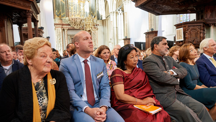 Members of the audience attending listening to His Holiness the Dalai Lama as speaks during the discussion on ‘Robotics and Telepresence’ at the Nieuwe Kerk in Amsterdam, Netherlands on September 15, 2018. Photo by Olivier Adam