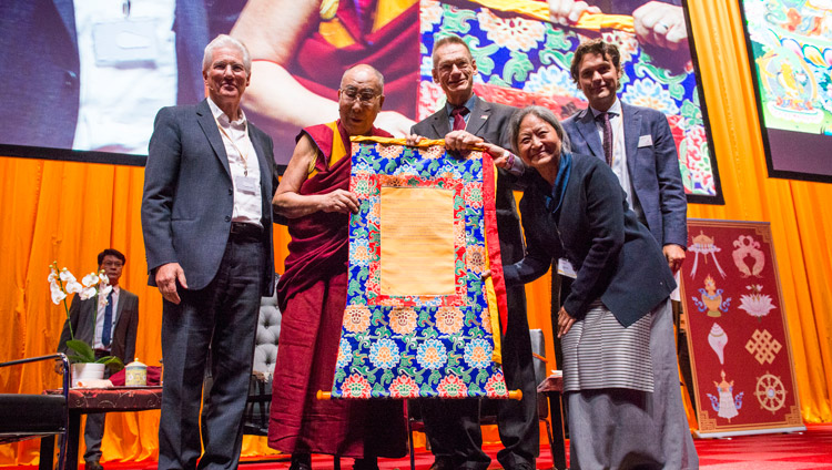 His Holiness the Dalai Lama and members of the International Campaign for Tibet (ICT) holding a certificate denoting the financial grant ICT will give to the Dalai Lama Institute for Higher Education as a gift of gratitude to His Holiness during their program at the Ahoy convention centre in Rotterdam, Netherlands on September 16, 2018. Photo by Jurjen Donkers