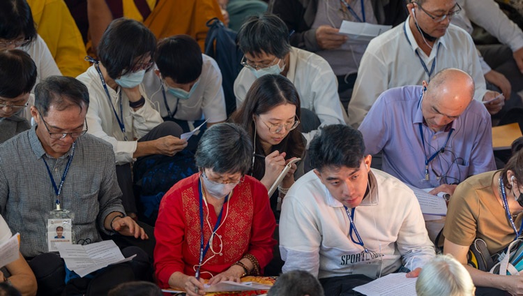 Members of the audience from Taiwan taking notes during His Holiness the Dalai Lama's teaching at the Main Tibetan Temple in Dharamsala, HP, India on September 30, 2024. Photo by Tenzin Choejor