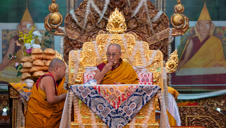 His Holiness the Dalai Lama enjoying a doughnut during the Long Life Prayer at Sera Lachi in Bylakuppe, Karnataka, India on February 5, 2025. Photo by Tenzin Choejor