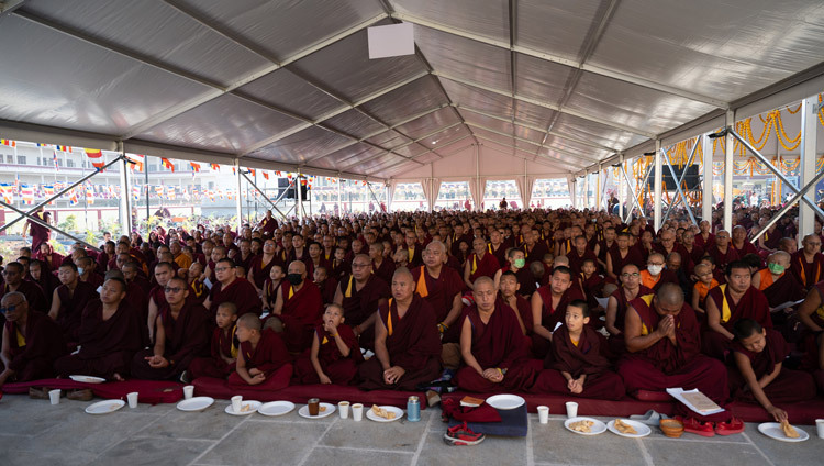 Monks and members of the Tibetan community watching the Long Life Prayers for His Holiness the Dalai Lama on a big screen in the courtyard of Gyudmed Tantric University in Hunsur, Karnataka, India on February 17, 2025. Photo by Tenzin Choejor