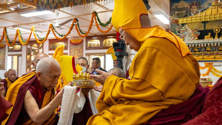 Prof Samdhong Rinpoché presenting traditional offerings to His Holiness the Dalai Lama during the Long Life Prayer at the Old Palace at His Holiness's residence in Dharamsala, HP, India on March 5, 2025. Photo by Tenzin Choejor